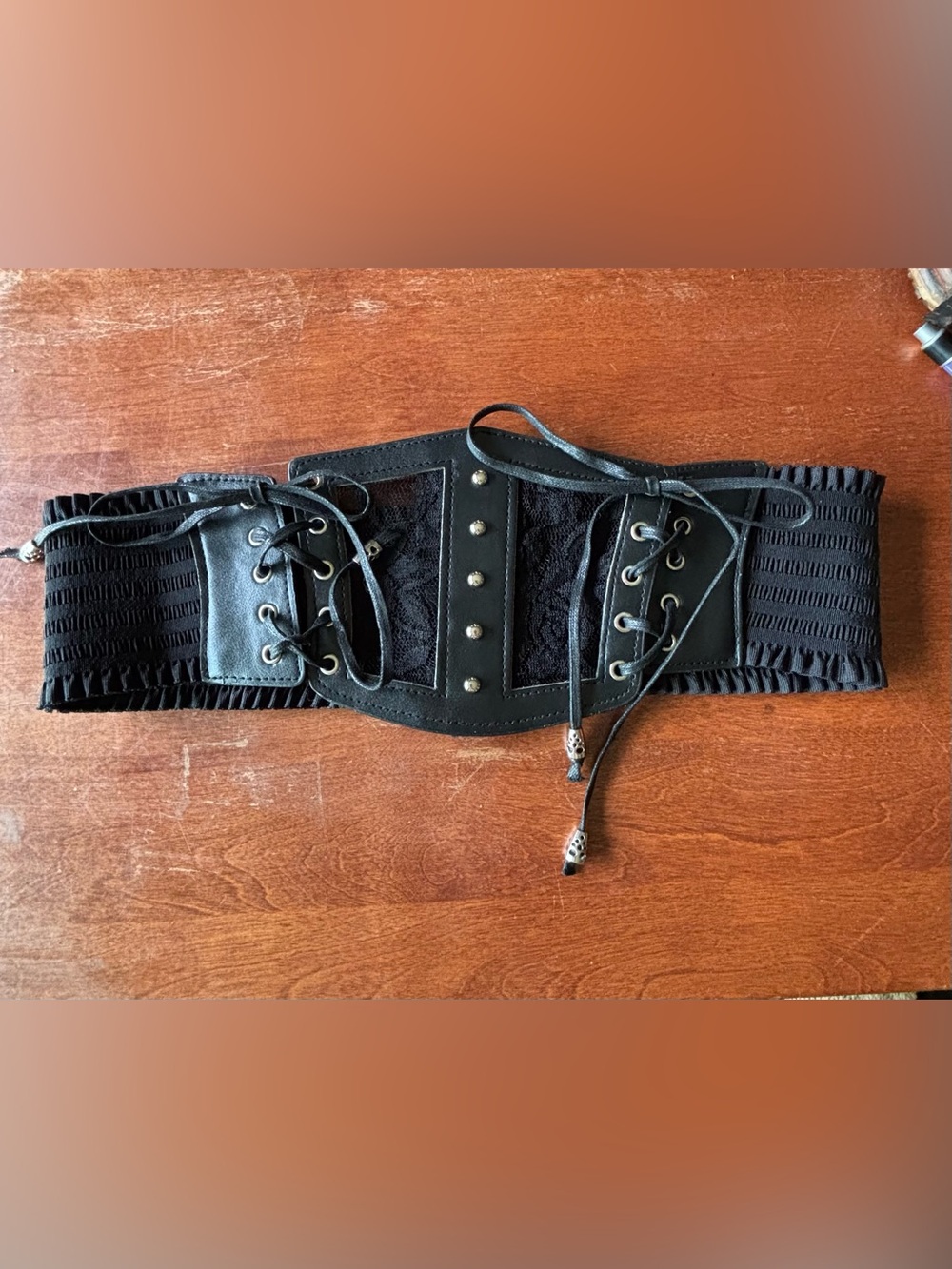 black gothic corset belt features lace-up details and silver hardware studs.
